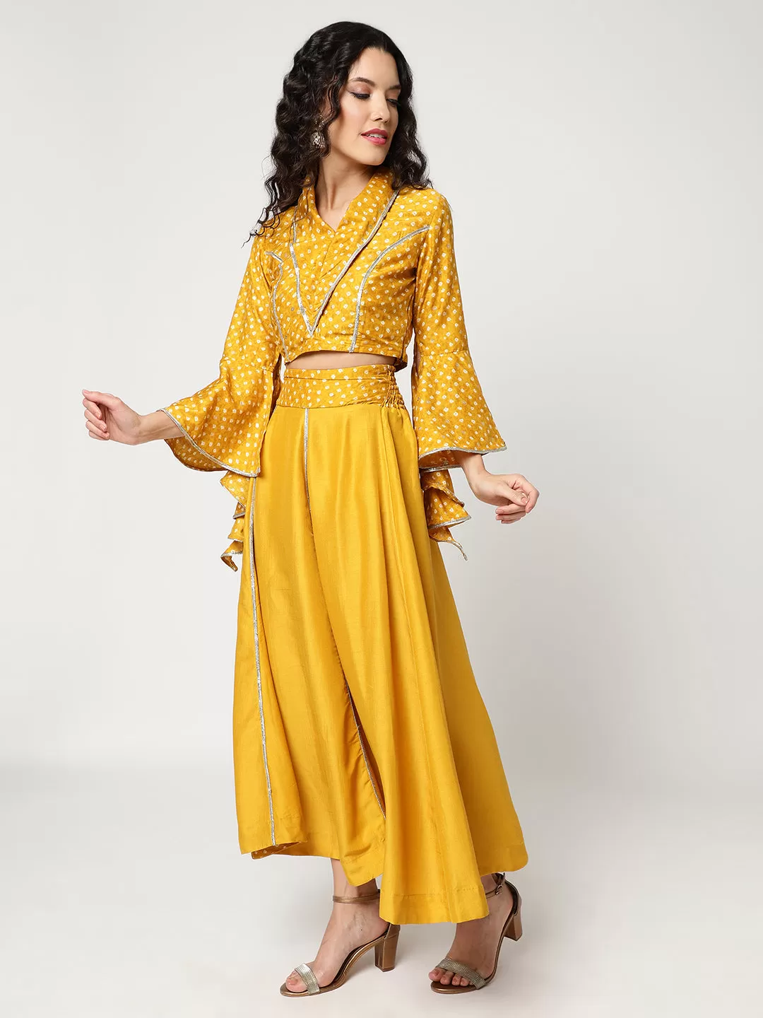 Bandhani Foil Printed Collared Crop Top Having Laces With Bell Sleeves And Solid Matching Flared Skirt Set